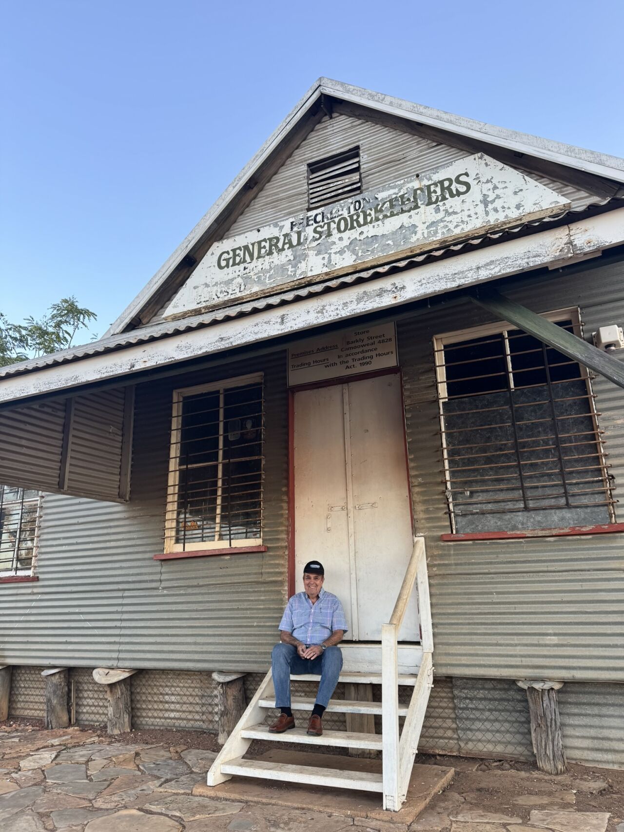 Barry sitting in front of the original Camooweal general store